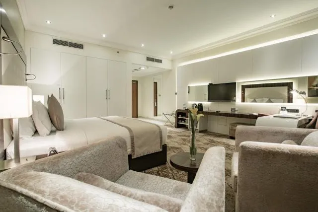  Elite Byblos Hotel - picture  : Seating area,Bed,Night,TV and multimedia,Photo of the whole room,Decorative detail,Seating area,Bedroom,wardrobe,air conditioner,Property,Room 