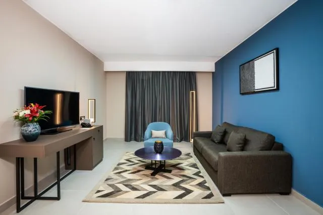  Hotel Holiday International - picture  : Seating area,TV/entertainment centre,Living room,Seating area,Property 