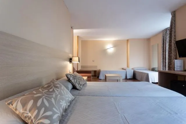  Hotel Panorama - picture  : Bed,Bed,TV and multimedia,Photo of the whole room,Seating area,Bedroom,Property,Room 