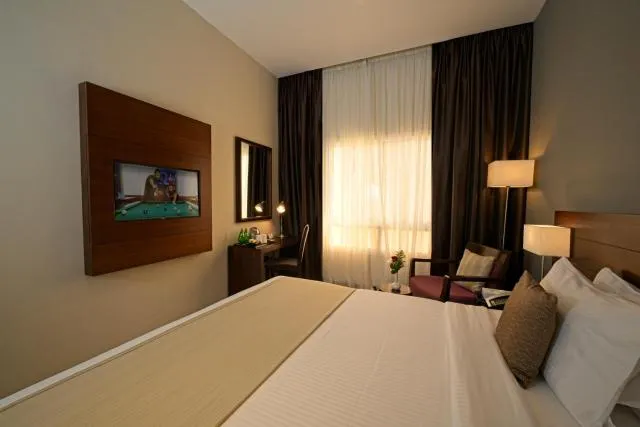  Action Hotel Ras Al Khaimah - picture  : TV/entertainment centre,Bed,Bed,Bedroom,Property,Room 
