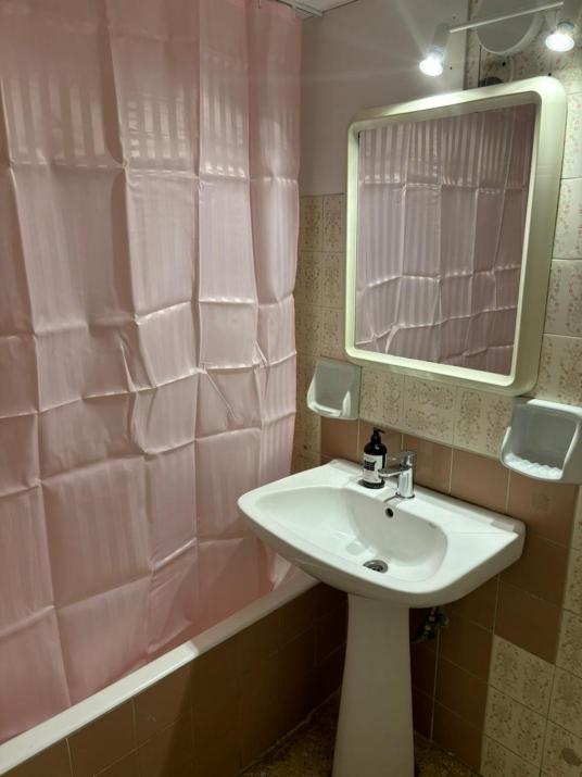 room with shared bath behind the kitchen