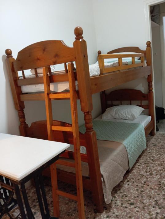 Wooden bunk bed in a dorm 5' from metro