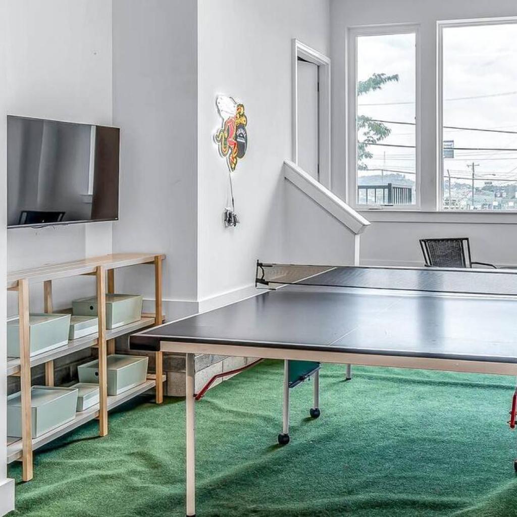 Photograph of Big NEW and Modern with Skyline View Mural and Ping Pong