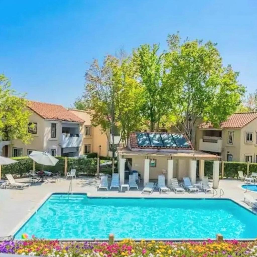 Photograph of Poolside 2BR Condo with Balcony & Workspace