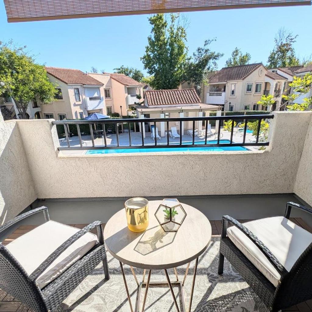 Photograph of Poolside 2BR Condo with Balcony & Workspace