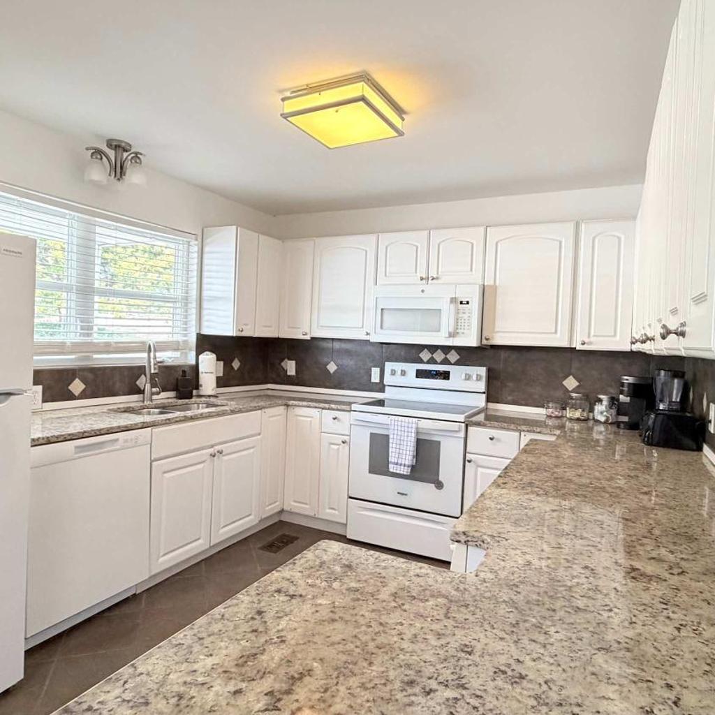 Photograph of Bright cheerful duplex with a pool A