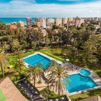 an overhead view of a pool with palm trees and the ocean at Intur Orange, Benicàssim