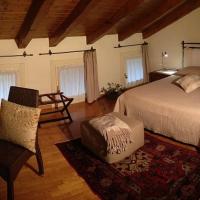 a bedroom with a bed and a desk and a television at La Dogana, Portogruaro