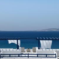 a view of the ocean from a resort with white chairs at San Marco Hotel and Villas, Houlakia