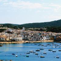 a group of boats in a body of water with buildings at Hotel Port-Bo, Calella de Palafrugell