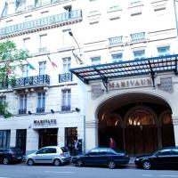 a large white building with cars parked in front of it at Marivaux Hotel, Brussels