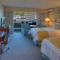 a hotel room with two beds and a television at Browns Wharf Inn, Boothbay Harbor