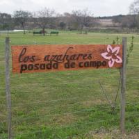 a sign on a fence in a field at Los Azahares, Carmelo