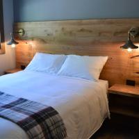 a bedroom with a large white bed with two lights at Sasquatch Inn, Harrison Mills