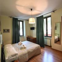 a bedroom with a large bed with green curtains at Palazzo Santori, Tivoli
