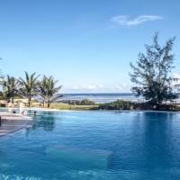 a swimming pool with the ocean in the background at The Charming Lonno Lodge Watamu