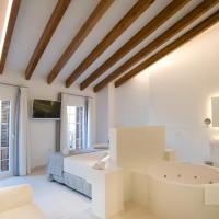 a white bedroom with a bed and a tub at Sindic Hotel - Adults Only, Mahón