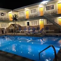 a swimming pool in front of a hotel at night at Sunrise Inn, Wildwood