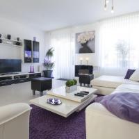 a living room with a white couch and a tv at Enschede