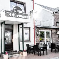 a restaurant with tables and chairs outside of it at Hotel Tum Stüürmann, Büsum