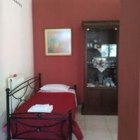 a bedroom with a red wall with a bed in it at Villa Eleni, Áfra