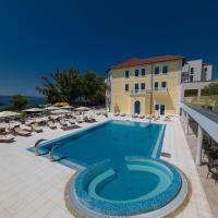 a swimming pool with chairs and a building at Boutique Hotel Esplanade, Crikvenica
