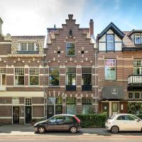 two cars parked in front of a large brick building at Bloemendaal Hotel Collection Apartments