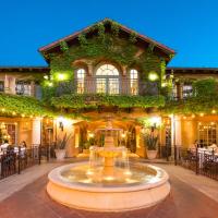 a courtyard with a fountain in front of a building at Hotel Los Gatos
