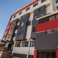 a tall building with a red and white at Hotel Regina, Cochabamba