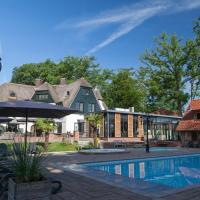 a swimming pool in front of a house at Huize Hölterhof Wellness Hotel Restaurant, Enschede