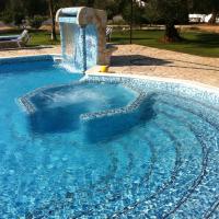 a large swimming pool with a water fountain at B&B Parcomonsignore, San Vito dei Normanni