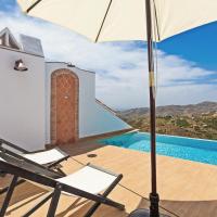 a patio with a chair and an umbrella and a swimming pool at EL TORREON 109 CHARMING B&B - Recomendado Adultos, Frigiliana