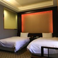 two beds sitting in a room with at Wanli Spa & Resort, Wanli District