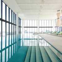 a pool in a building with chairs and windows at Crown Metropol Melbourne