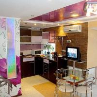 a kitchen with a table and chairs and a dining room at Nebesnoy sotni apartmens studio CENTER, Kherson