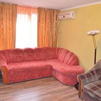 a living room with a red couch and a chair at Zheleznodorozhnaya Street Apartments Center, Kherson