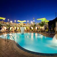a large swimming pool in a hotel at night at Pefkos Beach Studios & Apartments, Pefki