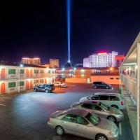 a parking lot with cars parked in front of buildings at Motel 6-Las Vegas, NV - Tropicana