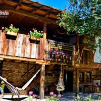 a wooden building with flower boxes on it at Kalinia Guesthouse B&B, Kovačevica