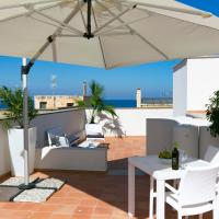 a patio with an umbrella and a table and chairs at ZIBIBBO SUITES & ROOMS - XIX Palazzo Mauro, Trapani