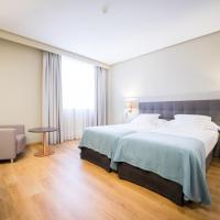 a hotel room with a large bed and a large window at Mercure Carlton Rioja, Logroño