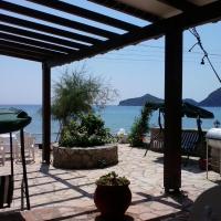a patio with a view of the ocean at Evgenios Studios, Agios Georgios Pagon