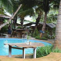 a picnic table in front of a swimming pool at Firefly Boutique Lodge, Bagamoyo