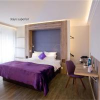a bedroom with a bed and a desk with a chair at stays design Hotel Dortmund