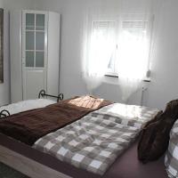 a bedroom with a bed with a checkered blanket at Appartement am Elzdamm, Emmendingen