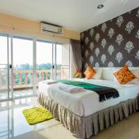 a bedroom with a large bed and a balcony at Surin Sunset Hotel - SHA, Surin Beach