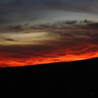 a sunset over a hill with a red sky at A&I Holiday House, Castelnuovo di Porto