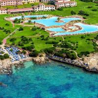an aerial view of a resort with blue water at Colonna Resort, Porto Cervo