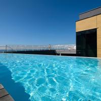 a swimming pool on the roof of a building at Hotel Split, Podstrana