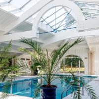 an indoor pool with plants in a building at Logis Domaine de Fompeyre, Bazas